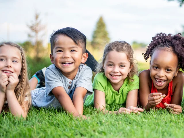 kids laying in grass